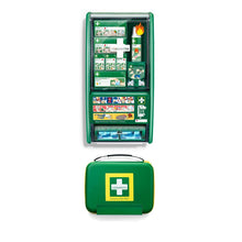 Ein grünes Orkla Wound Care AB Cederroth First Aid & Burn Station Set DIN 13157 (22,7x29,4x57,2 cm, 91 Teile) ist an der Wand über einem passenden geschlossenen tragbaren Set angebracht; beide zeigen ein gelb-weißes Kreuz-Logo.
