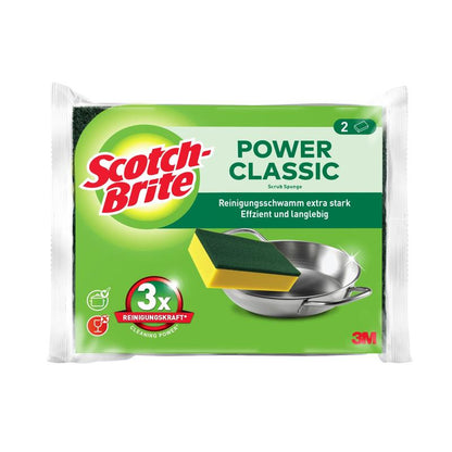 Un pachet de bureți de curățare Scotch-Brite® Classic de la 3M Deutschland GmbH arată doi bureți, o etichetă în germană, un branding de produs, un burete care curăță un vas de metal și mențiunea "3x puterea de curățare".