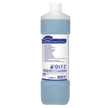 O sticlă de 1 litru TASKI Sprint Flower Detergent deodorant de întreținere de la Diversey Deutschland GmbH & Co. OHG conține un lichid albastru, un capac alb și o etichetă cu informații despre produs, instrucțiuni și simboluri de siguranță.