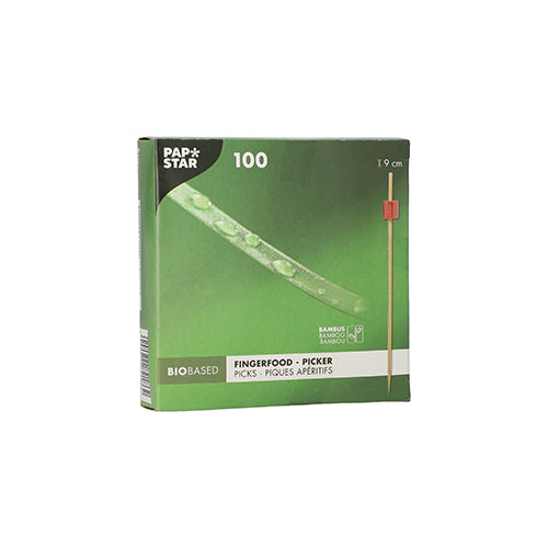 Die grüne Box "PAPSTAR 100 Fingerfood - Picker" der PAPSTAR GmbH enthält 100 Bambuspickel mit einer Länge von je 9 cm. Die biobasierte Verpackung zeigt einen Picker mit roter Spitze, ideal zum Servieren von Fingerfood Spieße auf jedem Event.