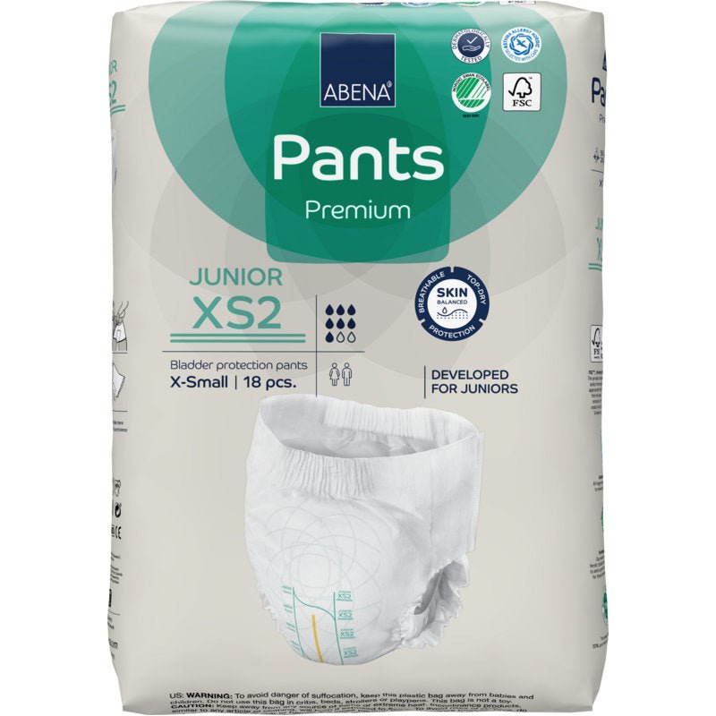 Un pachet de ABENA Pants Junior Premium, Gr. XS2 (18 bucăți) de la Abena Re-Seller GmbH oferă protecție pentru vezică pentru juniori. Ambalajul arată caracteristicile produsului, logourile de certificare și o ilustrație a scutecului.