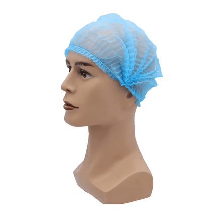 Un cap de păpușă poartă o plasă de păr albastră AMPri MED-COMFORT Klipphaube 52 cm, de la AMPri Handelsgesellschaft mbH. Plasa de păr din polipropilenă ușoară, cu margini elastice, se mulează strâns pe capul păpușii și oferă protecție igienică. Imaginea este vizibilă pe un fundal simplu alb.