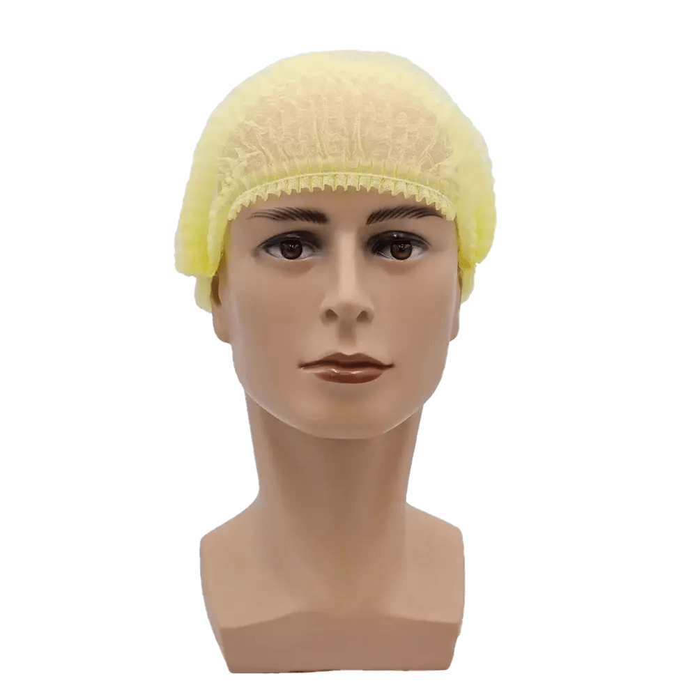 Un cap de păpușă prezintă o plasă galbenă AMPri MED-COMFORT Klipphaube 52 cm, fabricată din polipropilenă de către AMPri Handelsgesellschaft mbH, cu o expresie neutră pe un fundal simplu alb, subliniind astfel protecția igienică.