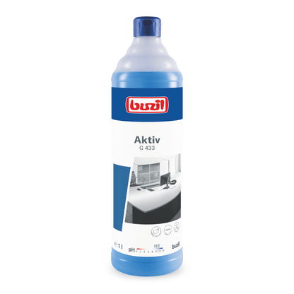 Pe un fundal alb se vede o sticlă de Detergent universal prietenos cu materialele Buzil Aktiv G 433 de la BUZIL-WERK Wagner GmbH & Co. KG. Sticla albastră poartă pe etichetă numele produsului și imaginea unui birou curat, care indică proprietățile delicate ale detergentului. Sticla are o capacitate de 1 litru.
