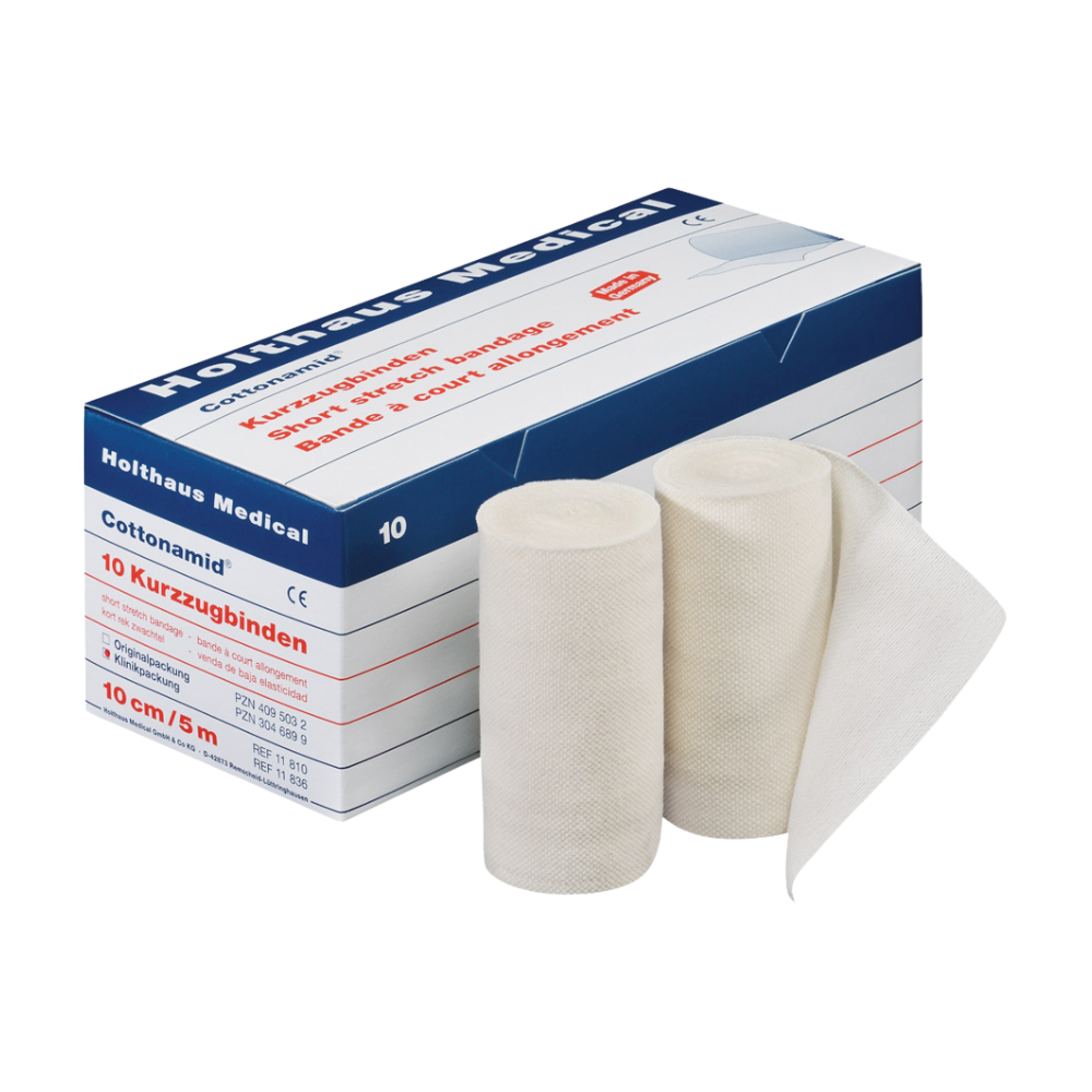 În imagine este o cutie de bandaje elastice Holthaus Cottonamid® Kurzzug, în fața căreia se văd două bandaje elastice albe desfășurate. Cutia este alb-albastră și are text roșu și conține 10 role, fiecare având 10 cm lățime și 5 metri lungime, ideală pentru terapia prin compresie. Acest produs este de la Holthaus Medical GmbH & Co. KG.