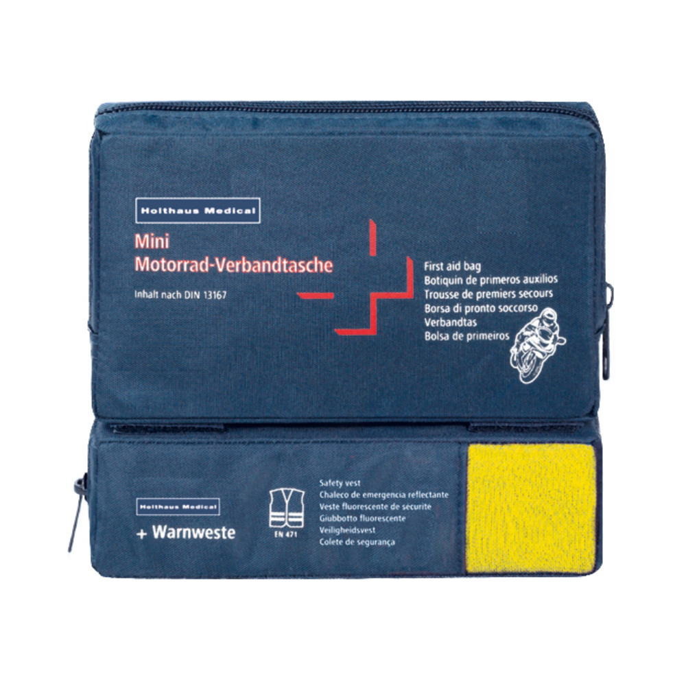 Un set de prim ajutor albastru cu inscripția „Holthaus Mini Combi Verbandtasche Motorrad“ de la Holthaus Medical GmbH & Co. KG cu text multilingv pentru motociclete. Acesta corespunde standardului DIN 13167 și conține o vestă reflectorizantă vizibilă printr-o secțiune transparentă. Mini Combi Verbandtasche dispune de două compartimente cu fermoar – unul deasupra și unul pe lateral.