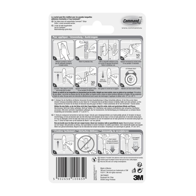 Partea din spate a unui ambalaj de cârlige pentru prosoape de baie Command™ de la 3M Deutschland GmbH, cu instrucțiuni ilustrate de utilizare și îndepărtare, avertismente de siguranță și informații despre produs în mai multe limbi. Logo-ul 3M și codul de bare sunt ilustrate în partea de jos.