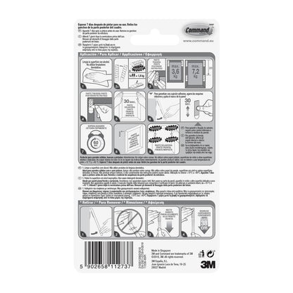 Partea din spate a benzilor de montare pentru imagini Command™ L de la 3M Deutschland GmbH, 6 seturi, arată pașii de aplicare/îndepărtare în engleză, spaniolă și franceză cu diagrame, limite de greutate, informații despre producător și cod de bare în partea de jos.