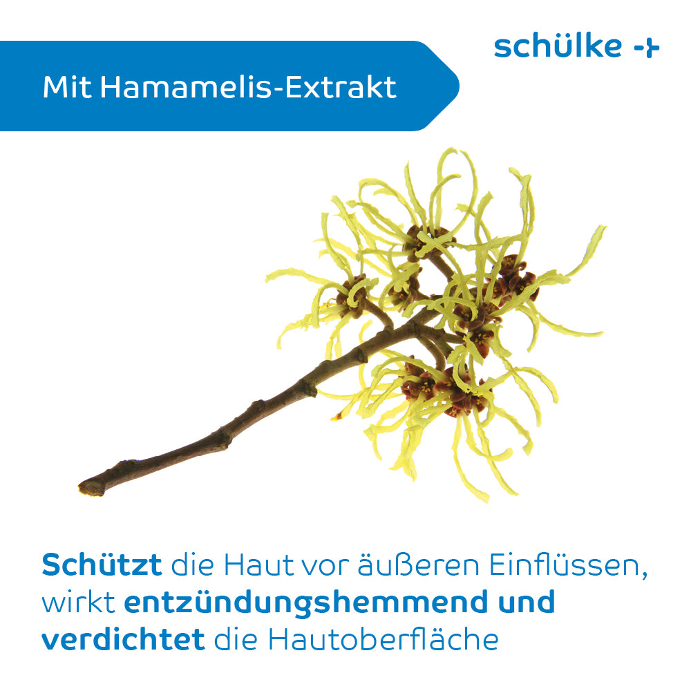 Pe un fundal alb este ilustrată o ramură de hamamelis cu flori galbene. Textul spune „Cu extract de hamamelis” și descrie în limba germană avantajele protectoare pentru piele, inclusiv ameliorarea iritațiilor pielii. Pe ambalajul cremei de protecție Schülke sensiva® este inscripționat cu albastru „Schülke & Mayr GmbH”.